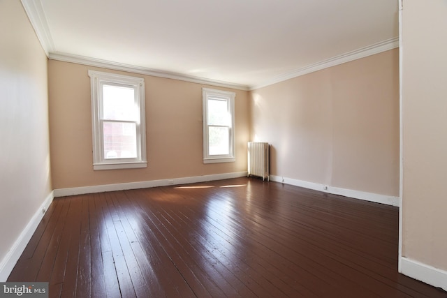 spare room with radiator heating unit, dark hardwood / wood-style floors, and crown molding