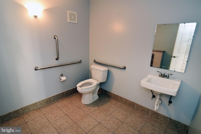 bathroom featuring tile patterned flooring, sink, and toilet