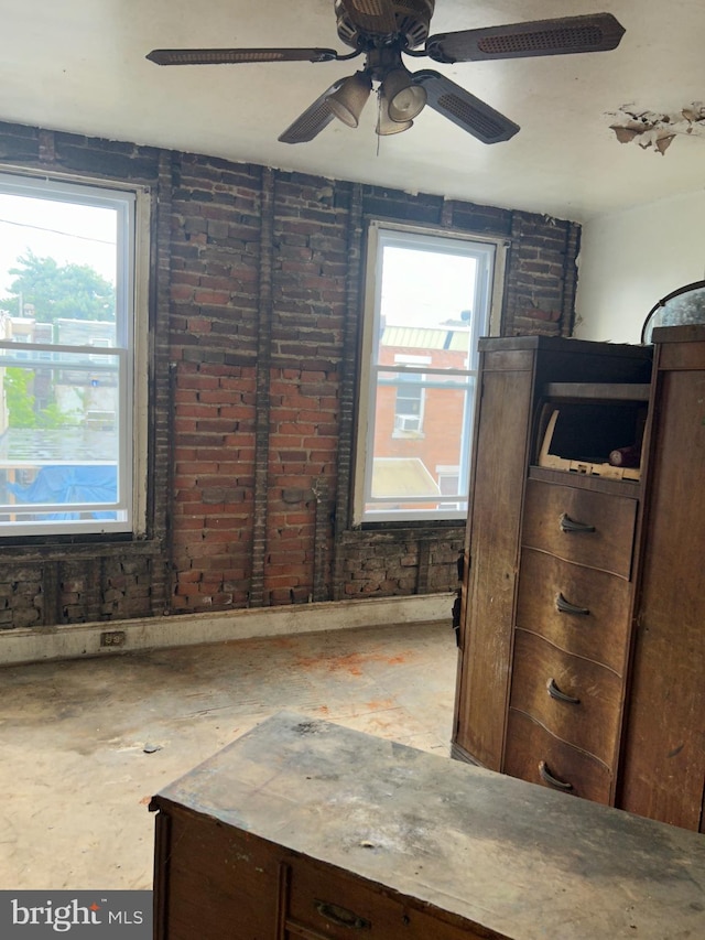 interior space featuring ceiling fan and multiple windows