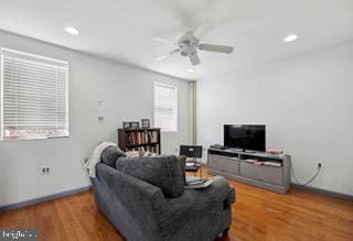 living room featuring ceiling fan and hardwood / wood-style floors