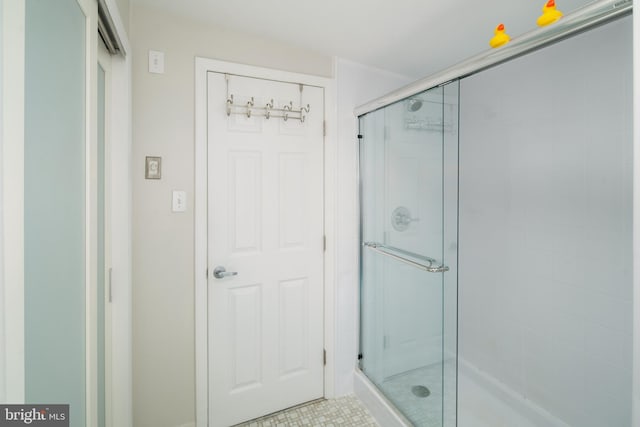 bathroom with a shower with shower door