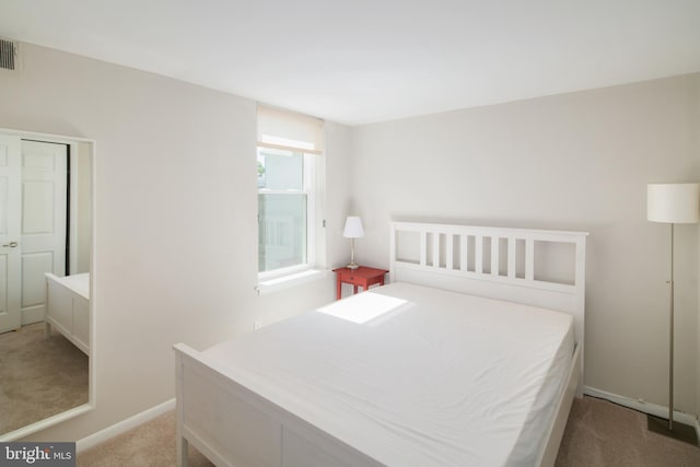 bedroom featuring light carpet