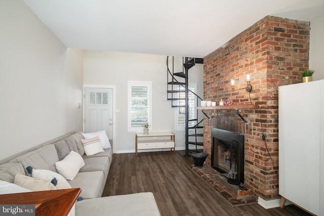 living room featuring a fireplace and dark hardwood / wood-style flooring