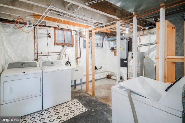 laundry room with washing machine and dryer, sink, and gas water heater