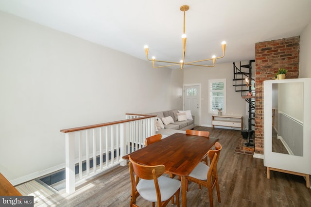 dining area featuring dark wood-type flooring and a notable chandelier