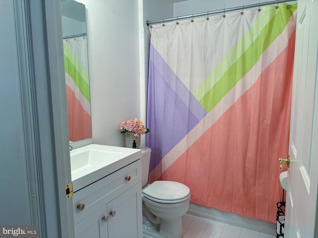 bathroom featuring a shower with shower curtain, vanity, toilet, and tile patterned floors