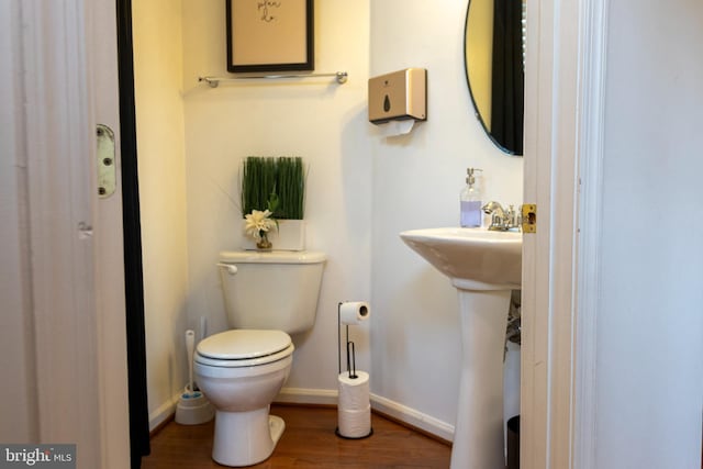 bathroom featuring wood-type flooring and toilet