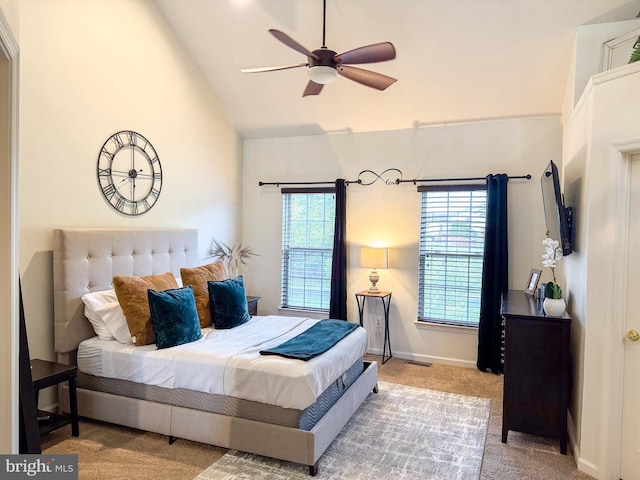 carpeted bedroom with high vaulted ceiling, multiple windows, and ceiling fan