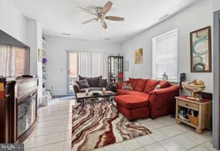 tiled living room with ceiling fan