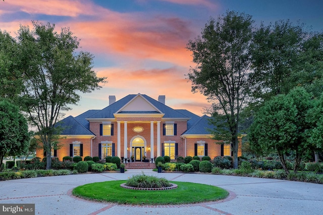 20459 Troyer Ln, Lincoln, DE 19960 - greek revival inspired property featuring brick siding, curved driveway, a yard, and a chimney