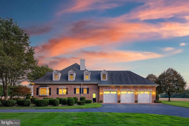 view of front facade featuring a yard and a garage