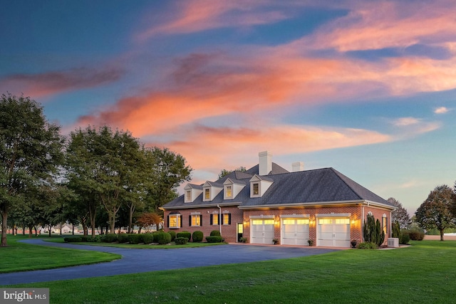 view of front of house featuring a yard and a garage