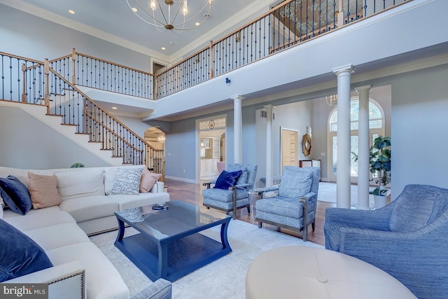 20459 Troyer Ln, Lincoln, DE 19960 - living room with a notable chandelier, a towering ceiling, ornamental molding, stairs, and decorative columns