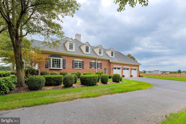 new england style home with a garage