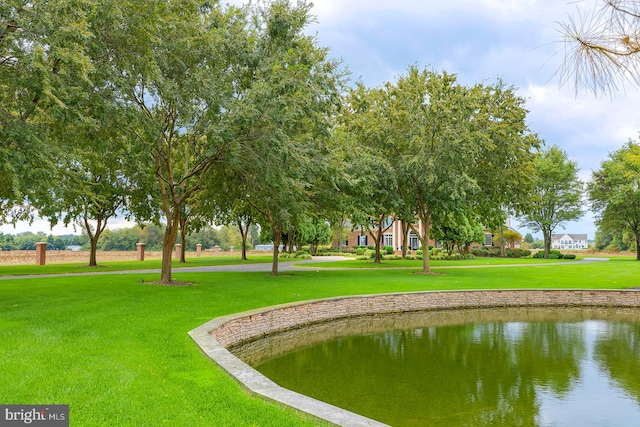 view of home's community featuring a yard and a water view