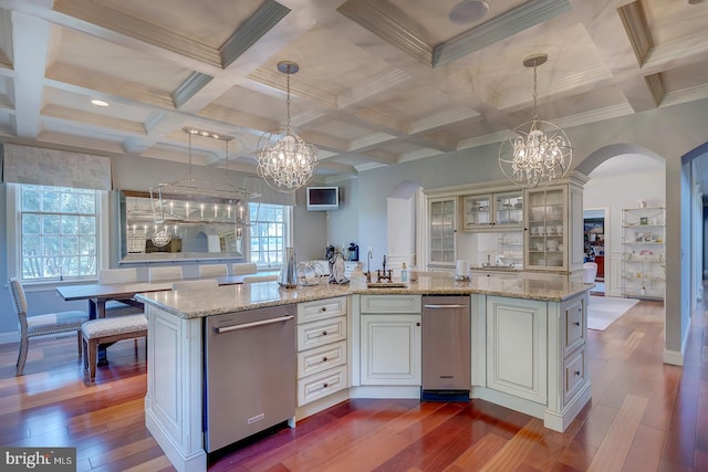 kitchen featuring a kitchen island with sink, wood-type flooring, and pendant lighting