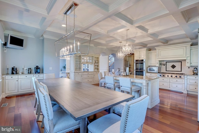 dining room with beam ceiling, ornamental molding, coffered ceiling, and dark hardwood / wood-style floors