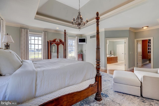 bedroom with crown molding, multiple windows, ensuite bathroom, and light wood-type flooring