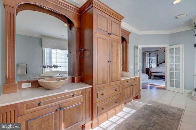 bathroom featuring vanity, ornamental molding, and tile patterned floors