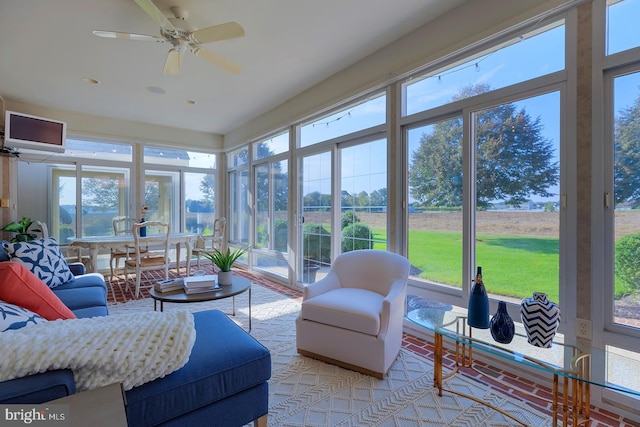 sunroom / solarium with ceiling fan and a wealth of natural light