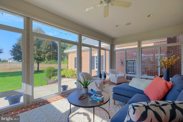 sunroom / solarium featuring ceiling fan