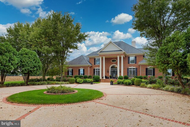 20459 Troyer Ln, Lincoln, DE 19960 - greek revival inspired property featuring brick siding, curved driveway, and a chimney
