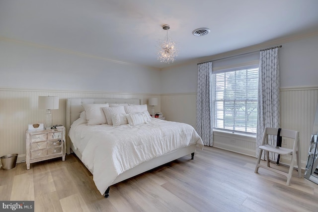 20459 Troyer Ln, Lincoln, DE 19960 - bedroom featuring a notable chandelier, ornamental molding, wainscoting, visible vents, and wood finished floors