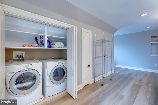 laundry room featuring light hardwood / wood-style flooring and separate washer and dryer