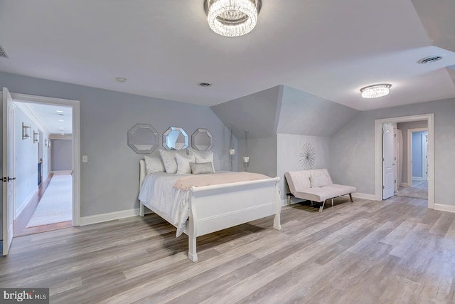 bedroom with lofted ceiling and light wood-type flooring