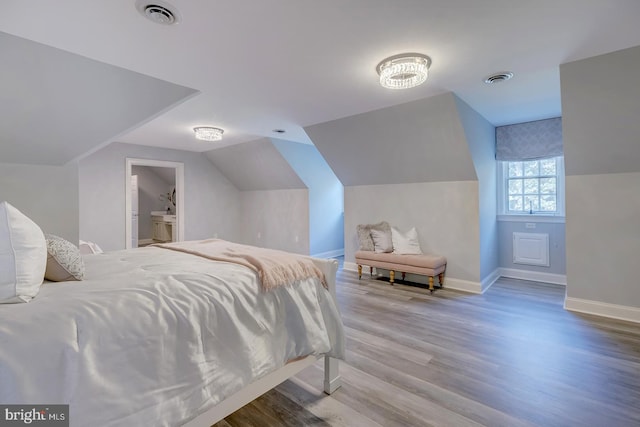 bedroom featuring lofted ceiling and hardwood / wood-style floors