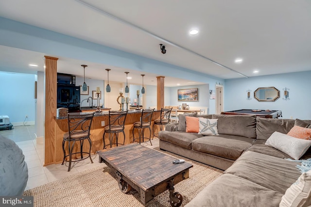 tiled living room with decorative columns and indoor bar