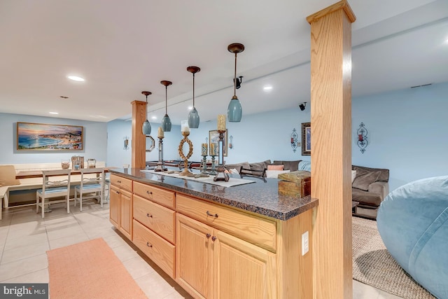 kitchen with light tile patterned flooring, decorative light fixtures, and light brown cabinetry