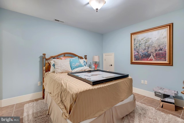 bedroom with light tile patterned floors