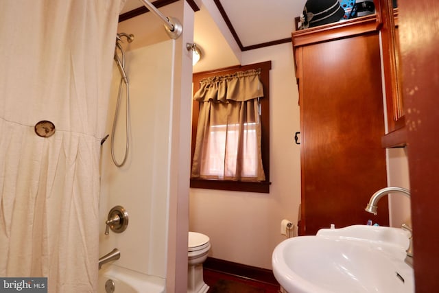 bathroom featuring ornamental molding, toilet, and shower / bath combo