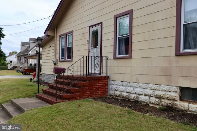 doorway to property with a yard