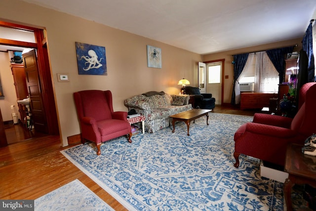 living room with cooling unit and hardwood / wood-style floors