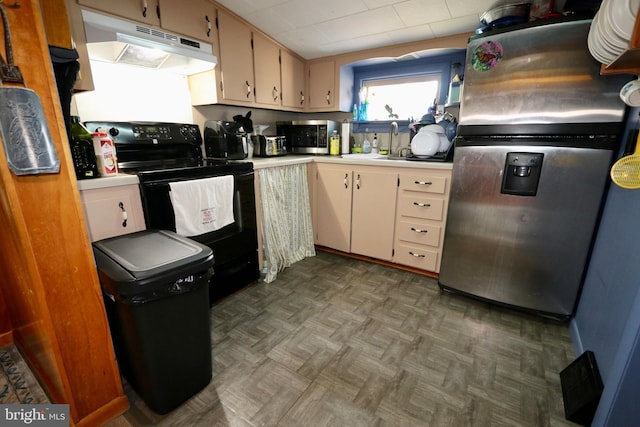 kitchen with dark parquet floors, appliances with stainless steel finishes, and sink