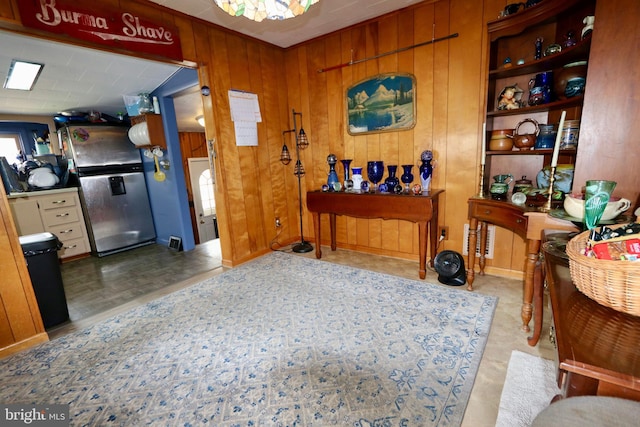 interior space with light hardwood / wood-style flooring and wood walls