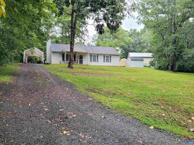 ranch-style house with a storage unit and a front yard