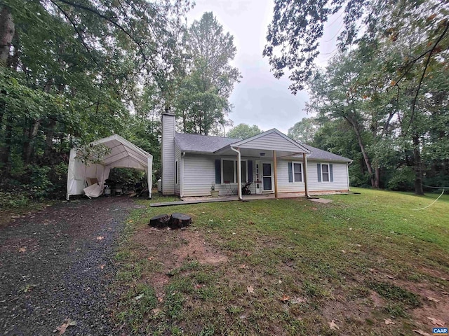 single story home featuring a front lawn and a patio area