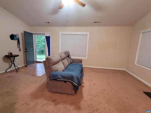 sitting room featuring ceiling fan and carpet