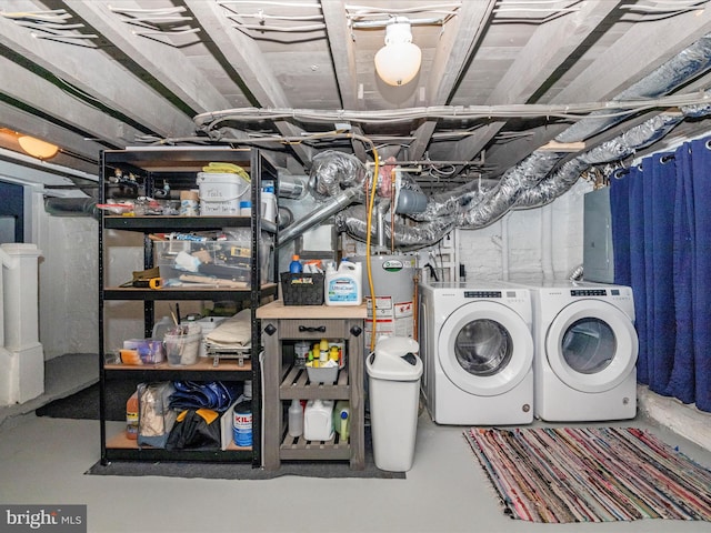 basement featuring water heater and washing machine and dryer