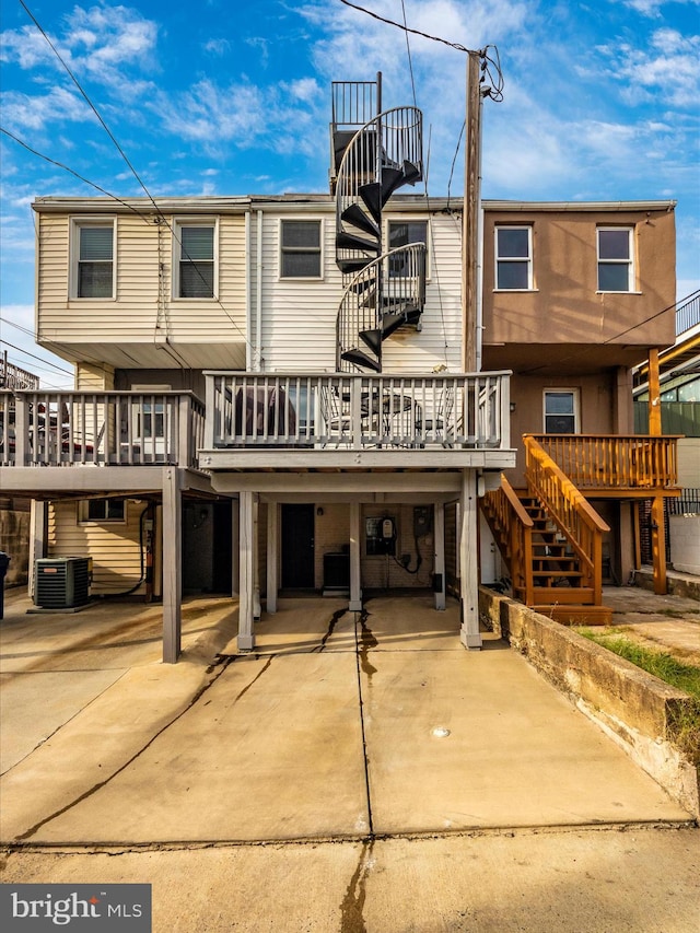 back of property featuring a deck and central AC unit