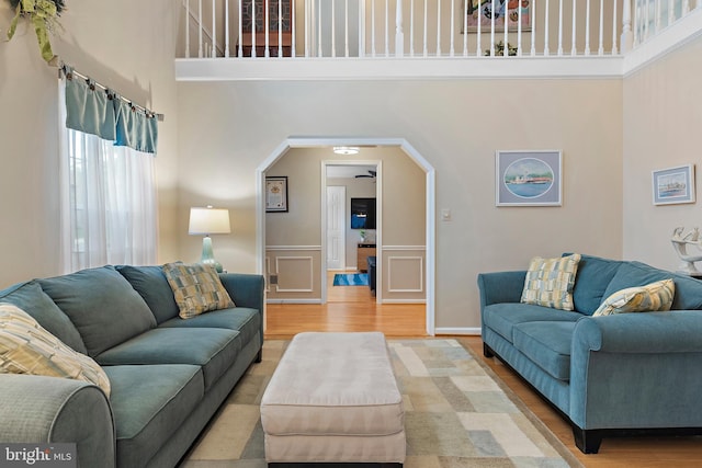 living room featuring hardwood / wood-style floors and a towering ceiling