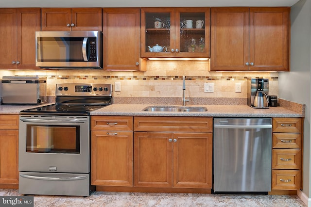 kitchen featuring sink, decorative backsplash, and stainless steel appliances