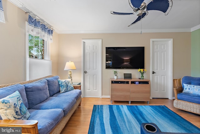 living room with ornamental molding, wood-type flooring, and ceiling fan