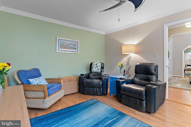 sitting room featuring ceiling fan, ornamental molding, and hardwood / wood-style floors