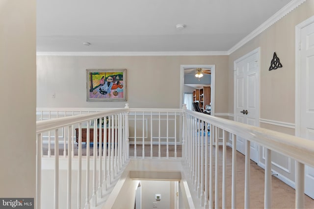 hallway featuring crown molding and light colored carpet