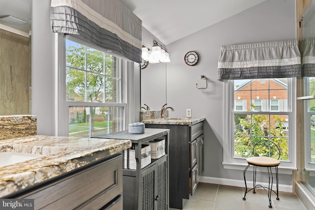 bathroom featuring tile patterned floors, lofted ceiling, and vanity