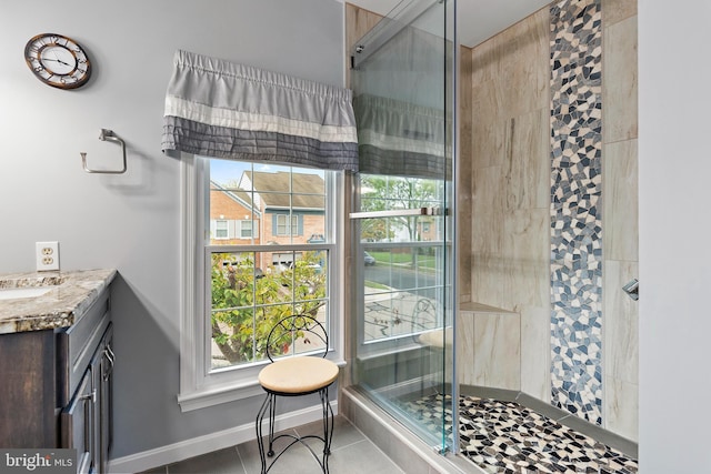 bathroom with vanity, tile patterned flooring, and a shower with shower door